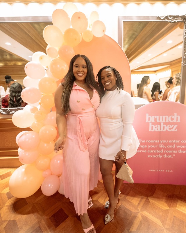 Guests posing at the Brunch Babez sign